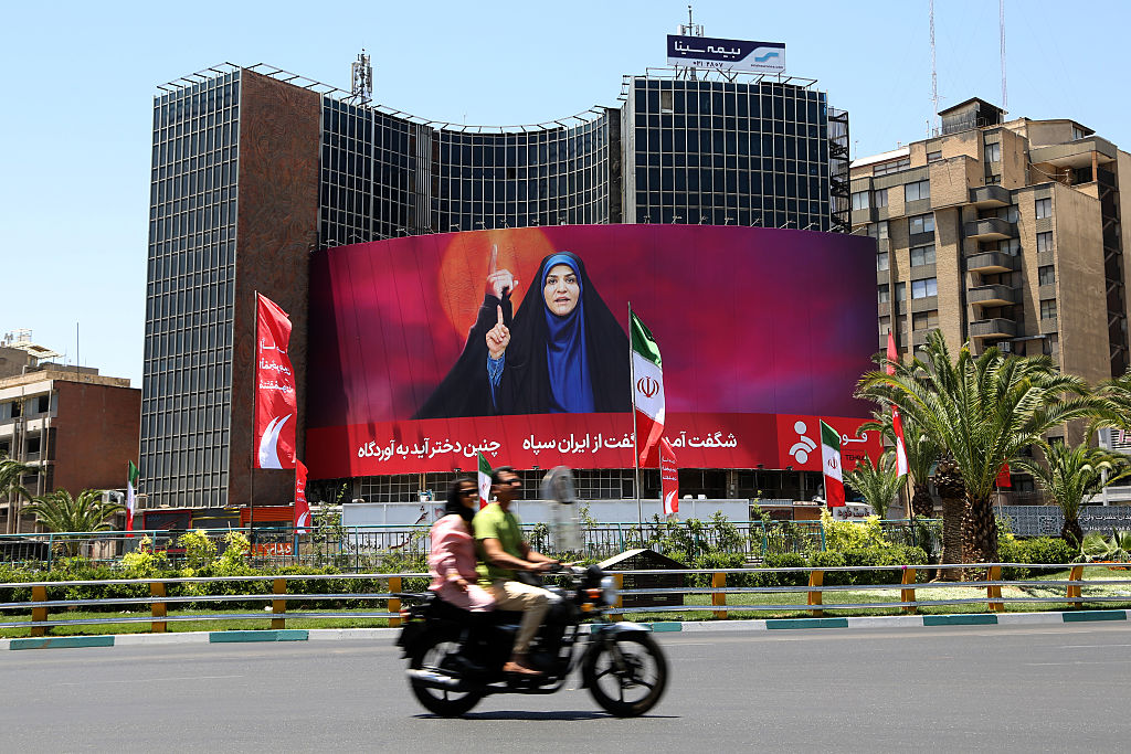 a sea of patterned green bugs with yellow bitcoin logos on them on a red background
