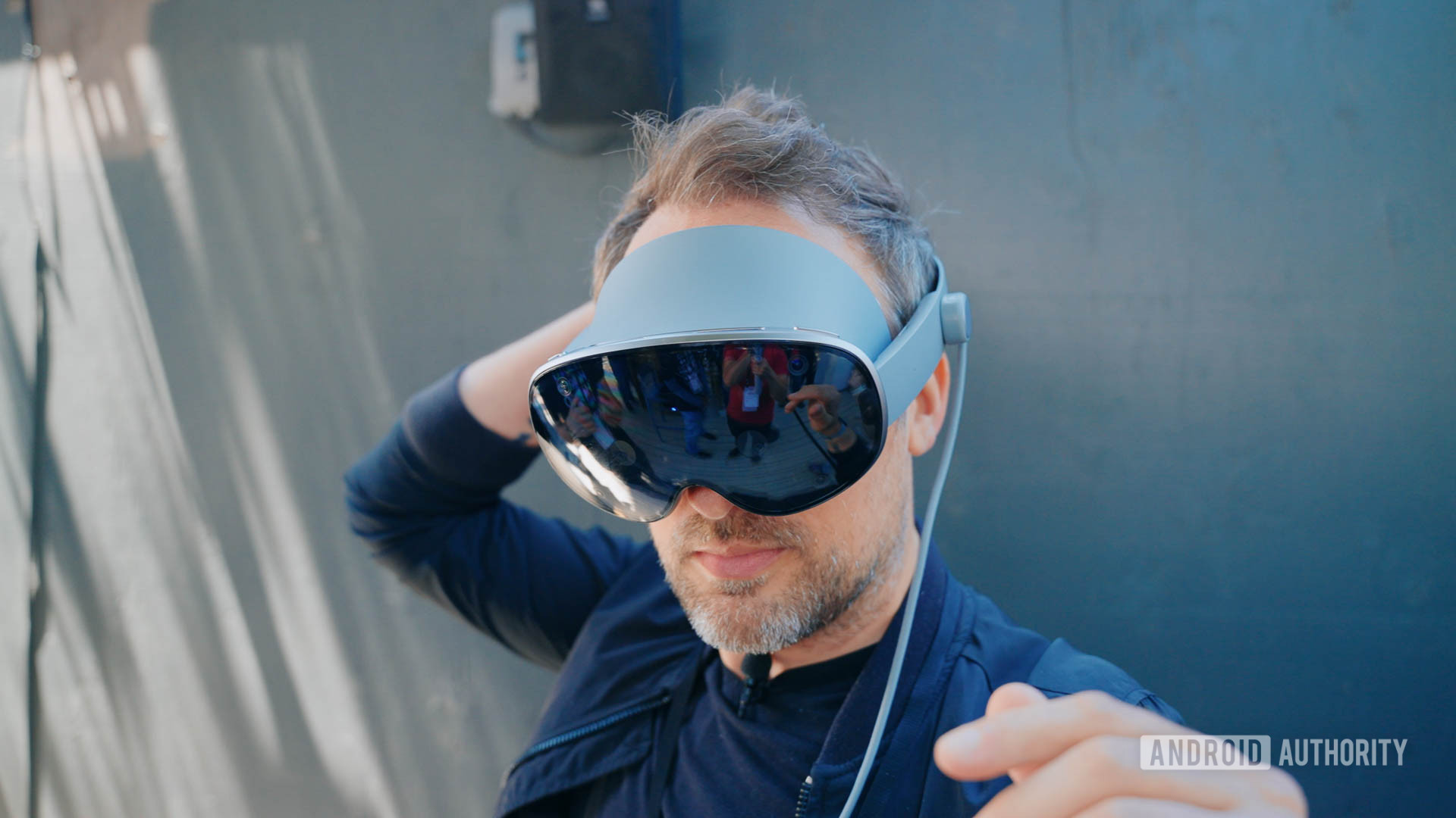 Google IO 2025 Project Moohan headset on man's head as he adjusts fit