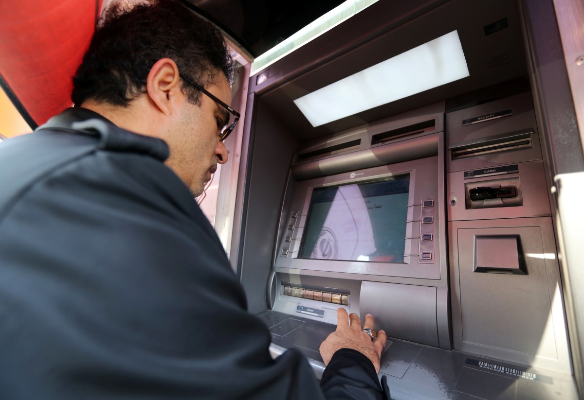 Customers use an automated teller machine (ATM) outside a Bank Sepah bank branch in Tehran, Iran, on Wednesday, Aug. 26, 2015.