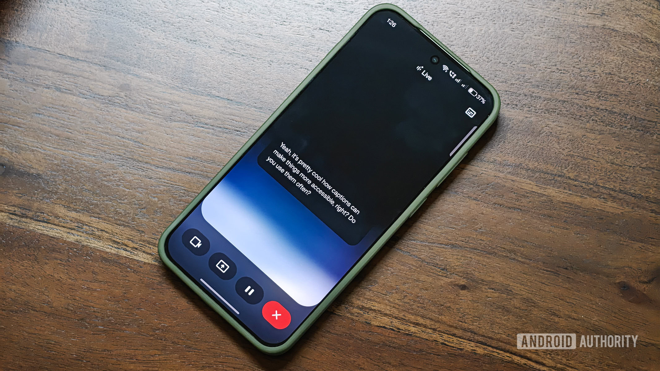 google gemini live captions on android app running on a OnePlus 13s kept on a wooden table surface.
