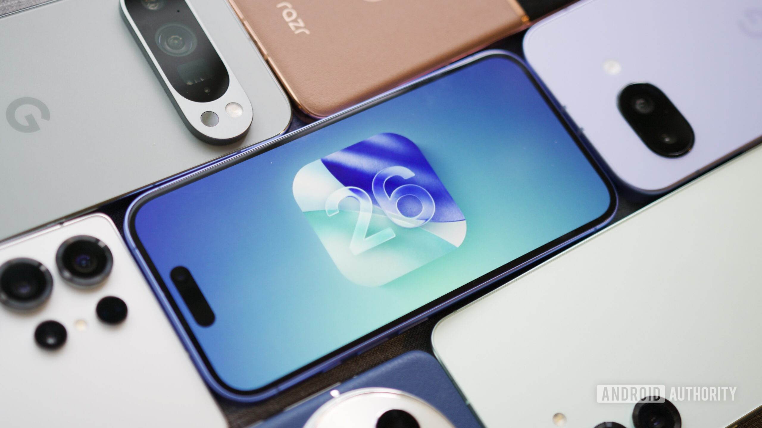 iPhone showing the iOS 26 logo, surrounded by Android phones.