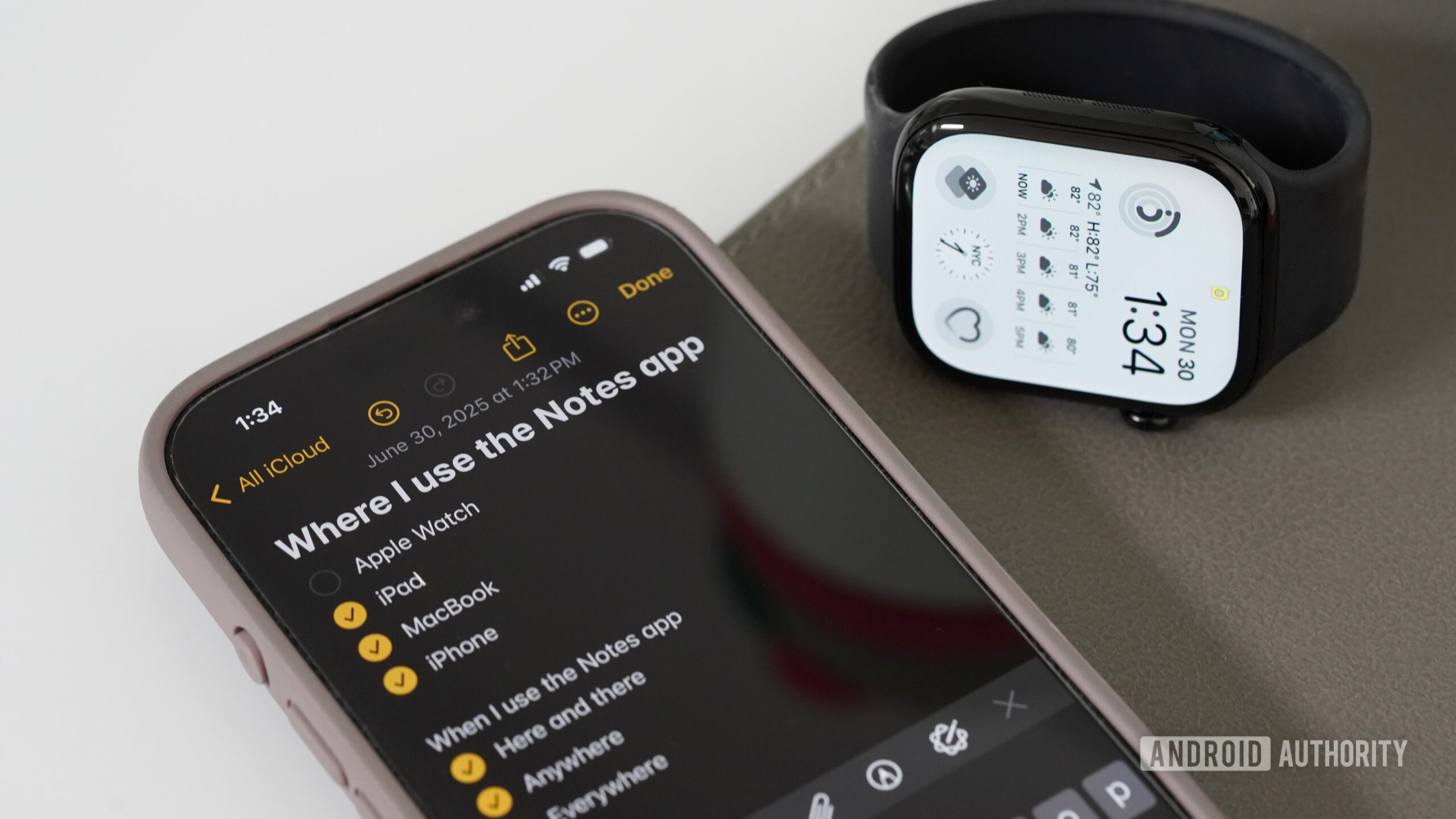 An Apple Watch rests next to an iPhone displaying the Notes app.