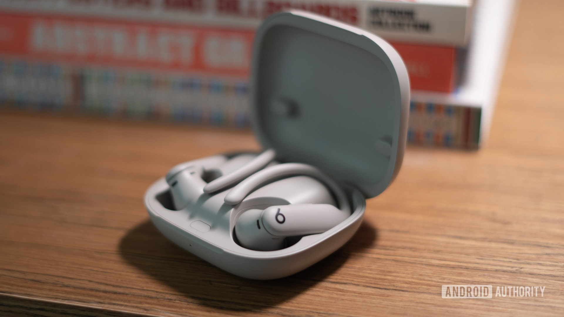 Beats PowerBeats Pro 2 case open on bookshelf