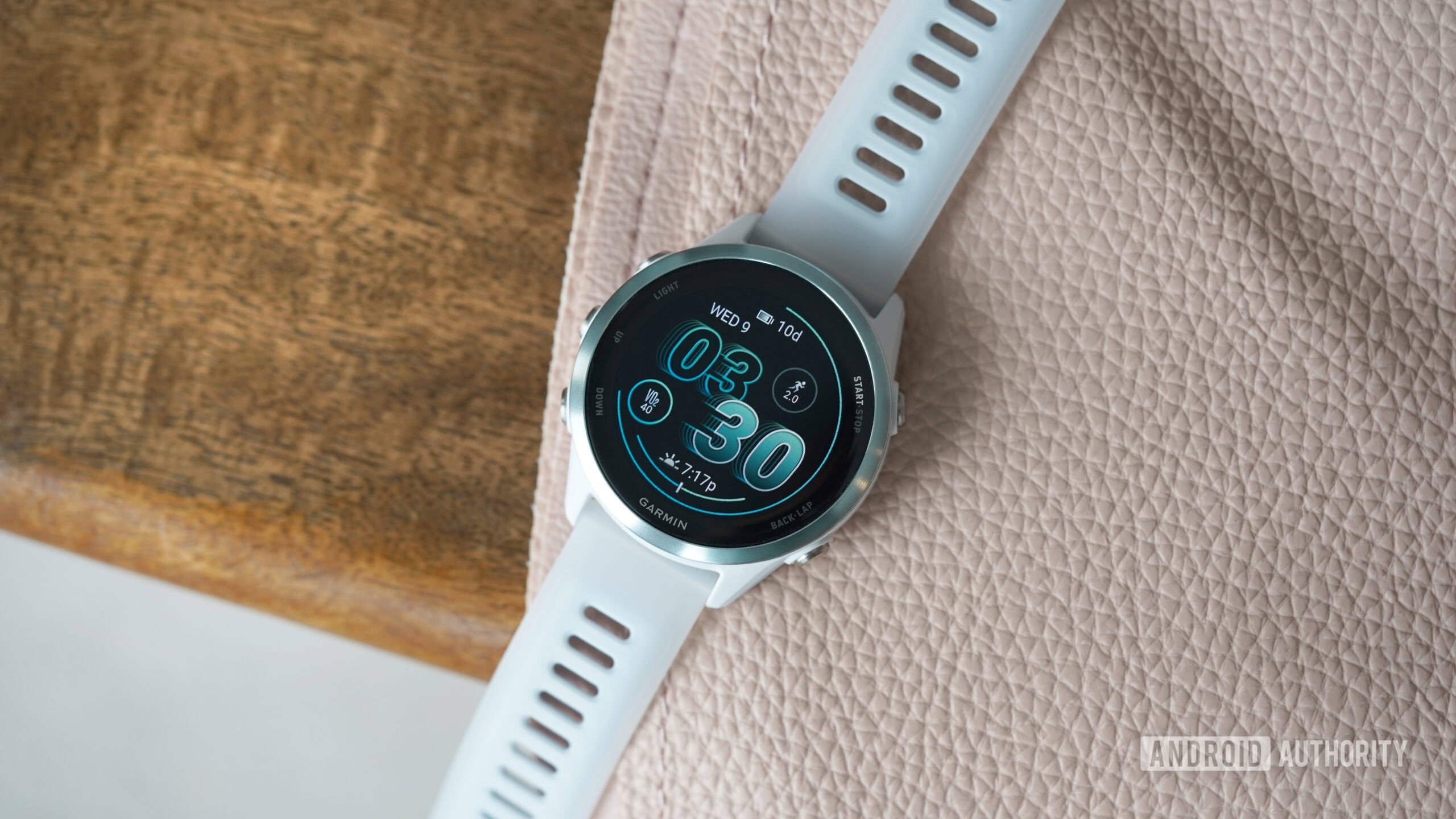 A Garmin Forerunner 570 displays the watch face.