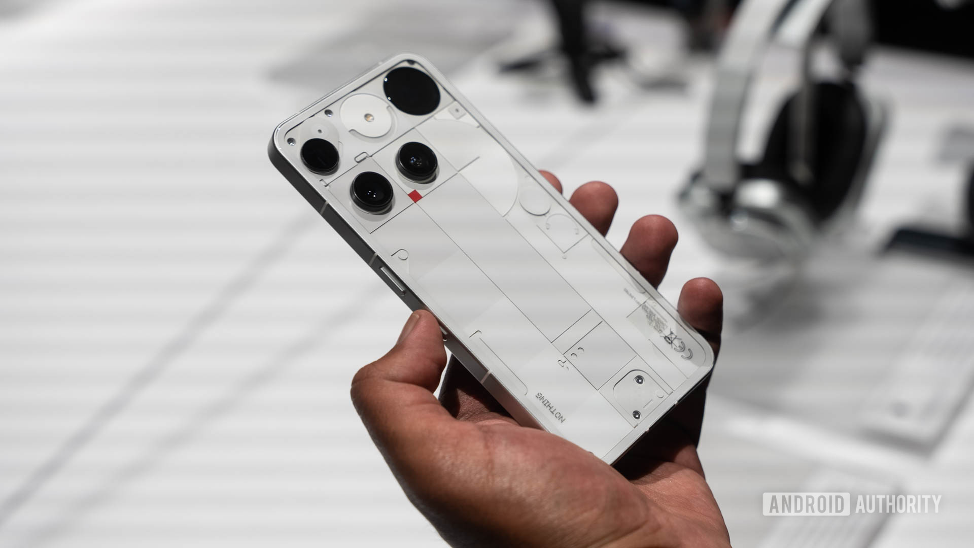 Nothing Phone 3 in White in a man's hands with thumb on Essential Key
