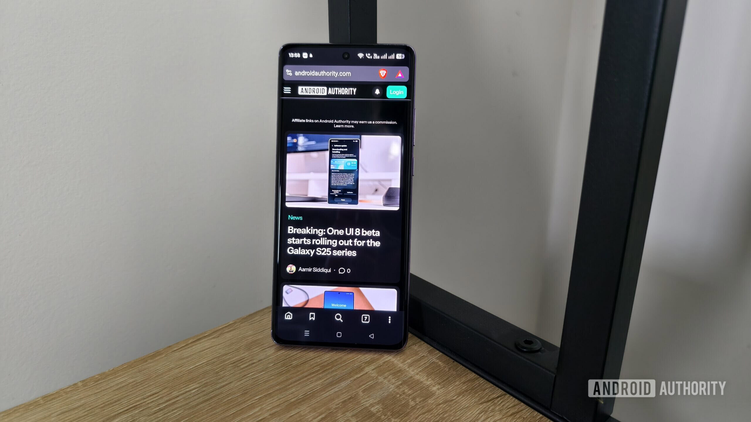 a smartphone showing the android authority site in dark mode